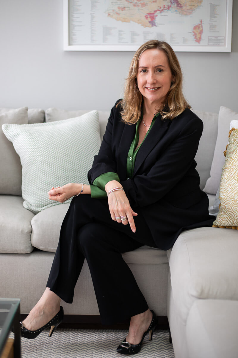 Business coach smiling while seated during brand photoshoot