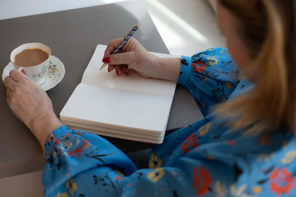 Woman planning in notebook during a brand shoot